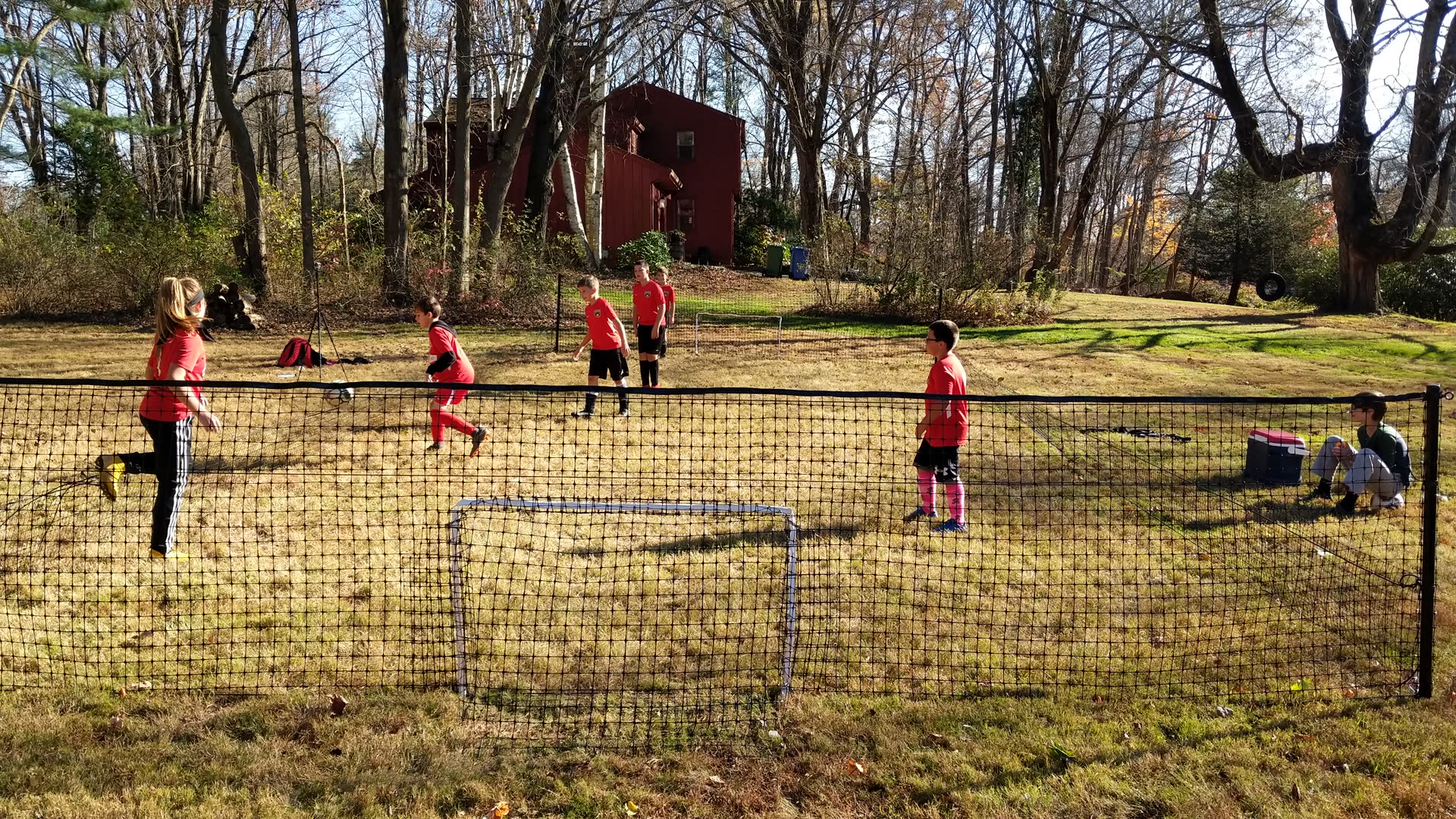 A coach running a small-sided session on a SoccerYards field