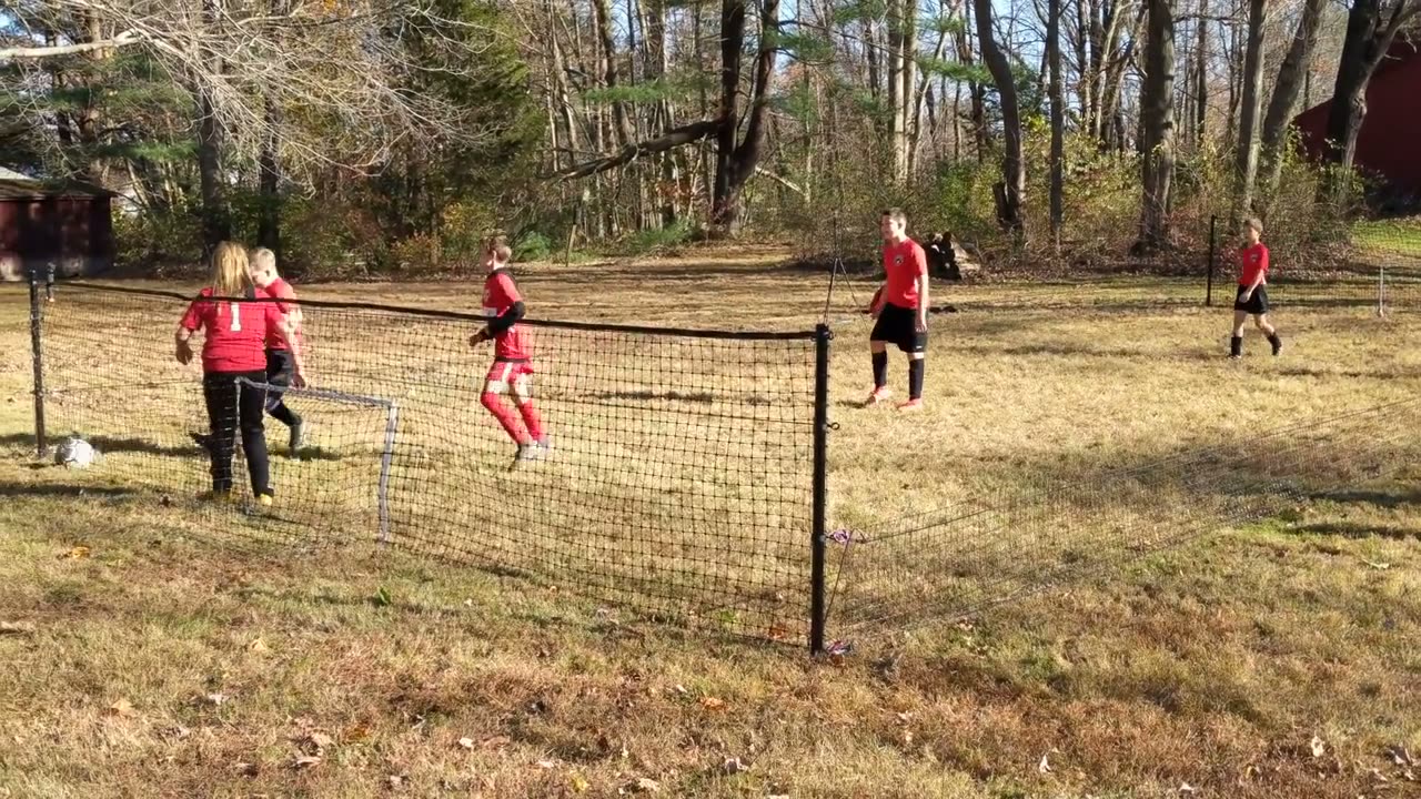 The field a team trained on: A full squad in matching kit, training in a garden-sized enclosure.